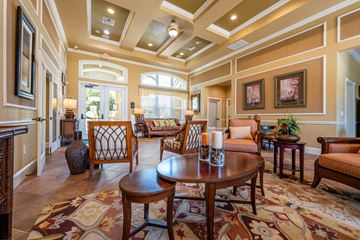 Riverview apartment for rent - A large, well-furnished living room with a patterned rug and wooden furniture.