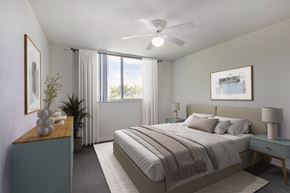 Lake Worth apartment for rent - A bedroom with a large bed and a ceiling fan.