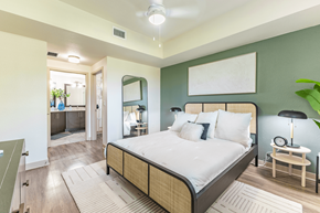 Davie apartment for rent - A bedroom with a large bed and a mirror on the wall.
