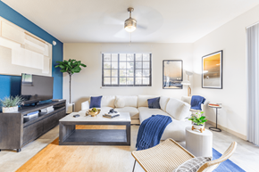 Davie apartment for rent - A living room with a white couch and a wooden coffee table.