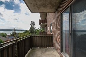 Barrie apartment for rent - A balcony with a view of the water and houses.