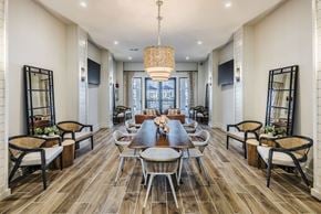 Huntersville apartment for rent - a dining room with a long table and chairs and a chandelier