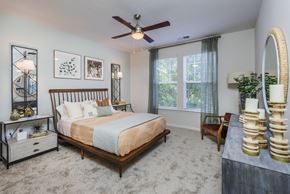 Huntersville apartment for rent - a bedroom with a large bed and a ceiling fan