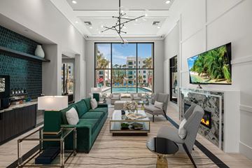 Naples apartment for rent - A modern living room with a green sofa and a fireplace.