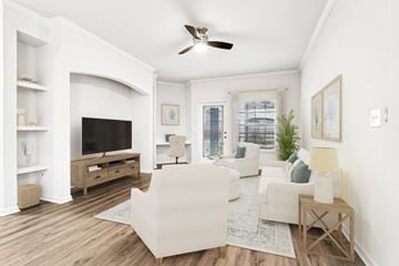 Sanford apartment for rent - A living room with a white couch and a television.