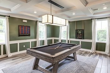 A game room with a pool table