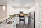 Quincy apartment for rent - a kitchen with stainless steel appliances and white cabinets at Highlands at Faxon Woods, Quincy, 02169