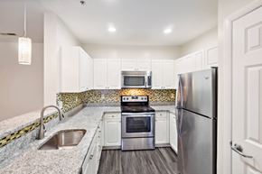 Quincy apartment for rent - a kitchen with stainless steel appliances and white cabinets at Highlands at Faxon Woods, Quincy, 02169