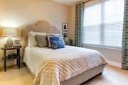 Charleston apartment for rent - A bedroom with a large bed and a lamp on a side table at Wharf 7 Apartments, Charleston, SC