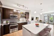 Atlanta apartment for rent - a kitchen with a large island and a white counter top at Glenwood at Grant Park Apartments, Atlanta