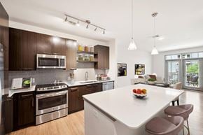 Atlanta apartment for rent - a kitchen with a large island and a white counter top at Glenwood at Grant Park Apartments, Atlanta