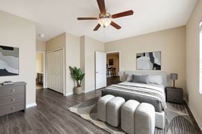 Ocala apartment for rent - A bedroom with a large bed and a ceiling fan.