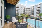 Atlanta apartment for rent - a balcony with chairs and a pool and an apartment building at Glenwood at Grant Park Apartments, Georgia