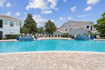A large swimming pool with a house in the background  at ballantrae apartments, florida, 32771