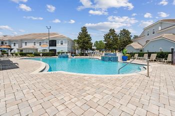 A large swimming pool with a house in the background  at ballantrae apartments, florida, 32771
