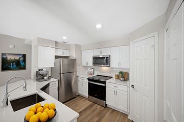 Austin apartment for rent - a kitchen with stainless steel appliances and white cabinets