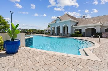 A large swimming pool with a house in the background  at ballantrae apartments, florida, 32771