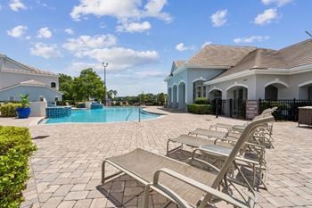 A large swimming pool with a house in the background  at ballantrae apartments, florida, 32771