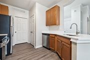 Sanford apartment for rent - An open-concept apartment with updated lighting, stainless steel appliances, quartz countertops, vinyl plank wood style flooring and wooden cabinets.