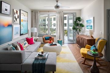 Sarasota apartment for rent - a living room with a gray couch and a large window