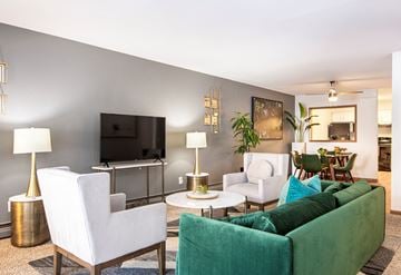 Madison apartment for rent - a living room with a couch and chairs and a television