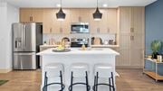Port St. Lucie apartment for rent - A modern kitchen with a white island and stainless steel appliances. at Lucie at Tradition Apartments, Port St. Lucie, Florida