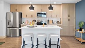 Port St. Lucie apartment for rent - A modern kitchen with a white island and stainless steel appliances. at Lucie at Tradition Apartments, Port St. Lucie, Florida