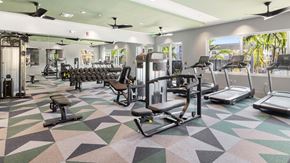 Port St. Lucie apartment for rent - A gym with a variety of equipment including treadmills, weights, and exercise machines. at Lucie at Tradition Apartments, Port St. Lucie, Florida