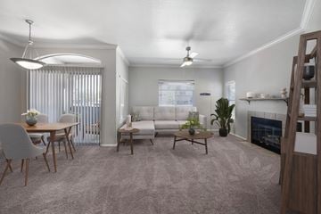Albuquerque apartment for rent - A living room with a grey carpet and a fireplace.