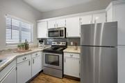 Albuquerque apartment for rent - A modern kitchen with a stainless steel refrigerator, microwave, and oven.