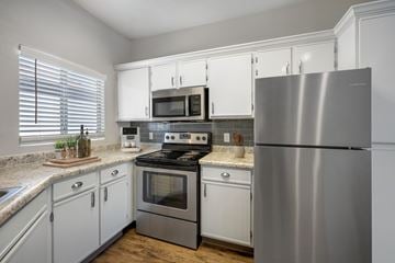 Albuquerque apartment for rent - A modern kitchen with a stainless steel refrigerator, microwave, and oven.