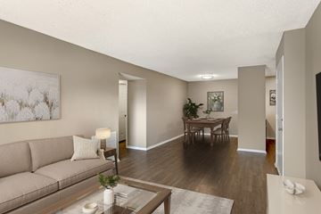 Corpus Christi apartment for rent - A living room with a couch, coffee table, and a painting on the wall.