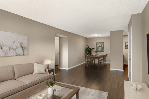 Corpus Christi apartment for rent - A living room with a couch, coffee table, and a painting on the wall.
