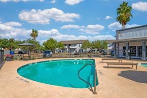 Corpus Christi apartment for rent - A swimming pool surrounded by a fence and a playground.