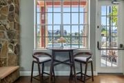 Plant City apartment for rent - A dining room with a table and chairs in front of a large window.