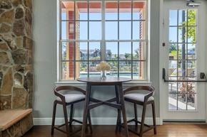 Plant City apartment for rent - A dining room with a table and chairs in front of a large window.