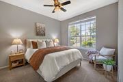 Plant City apartment for rent - A bedroom with a large bed and a ceiling fan.