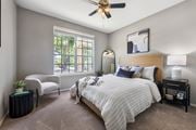 Plant City apartment for rent - A bedroom with a large bed and a window with a view of the street outside.