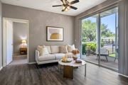 Plant City apartment for rent - A living room with a white couch and a ceiling fan.