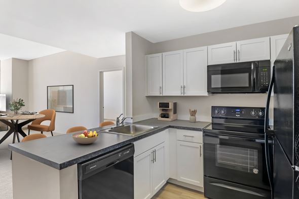 Enfield apartment for rent - Open Concept Kitchen with white cabinets and wood style plank flooring