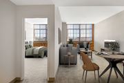 Enfield apartment for rent - A modern living room with an exposed brick wall and a large window.