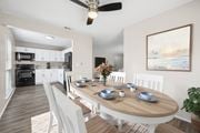 Indialantic apartment for rent - A modern dining room with a wooden table set for six.