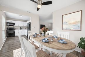 Indialantic apartment for rent - A modern dining room with a wooden table set for six.