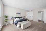 Indialantic apartment for rent - A bedroom with a bed, nightstand, and a plant.