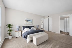 Indialantic apartment for rent - A bedroom with a bed, nightstand, and a plant.