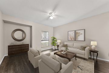 Austin apartment for rent - A living room with a brown wooden dresser and a white couch.