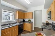 Fort Myers apartment for rent - A kitchen with wooden cabinets and a black oven.