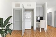 Sarasota apartment for rent - A white chair is in front of a small kitchen.
