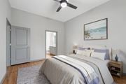 Sarasota apartment for rent - A bedroom with a large bed and a ceiling fan.