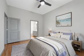 Sarasota apartment for rent - A bedroom with a large bed and a ceiling fan.
